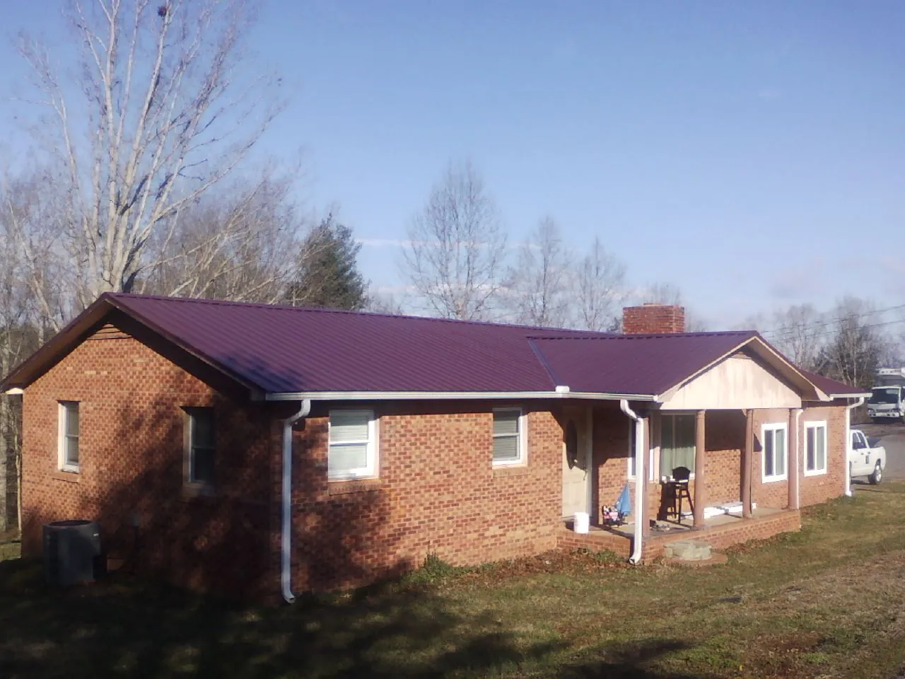 Burgundy metal roof on a brick ranch home with a new addition in Whiteford
