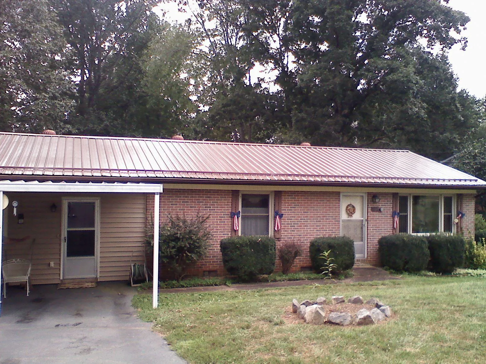 Bronze metal roof and carport on a brick ranch home — Roof Repair work by our crew in Whiteford